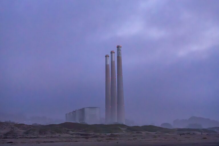 Industrial power plant glowing against a twilight sky representing New Zealand gas shortage and energy security.