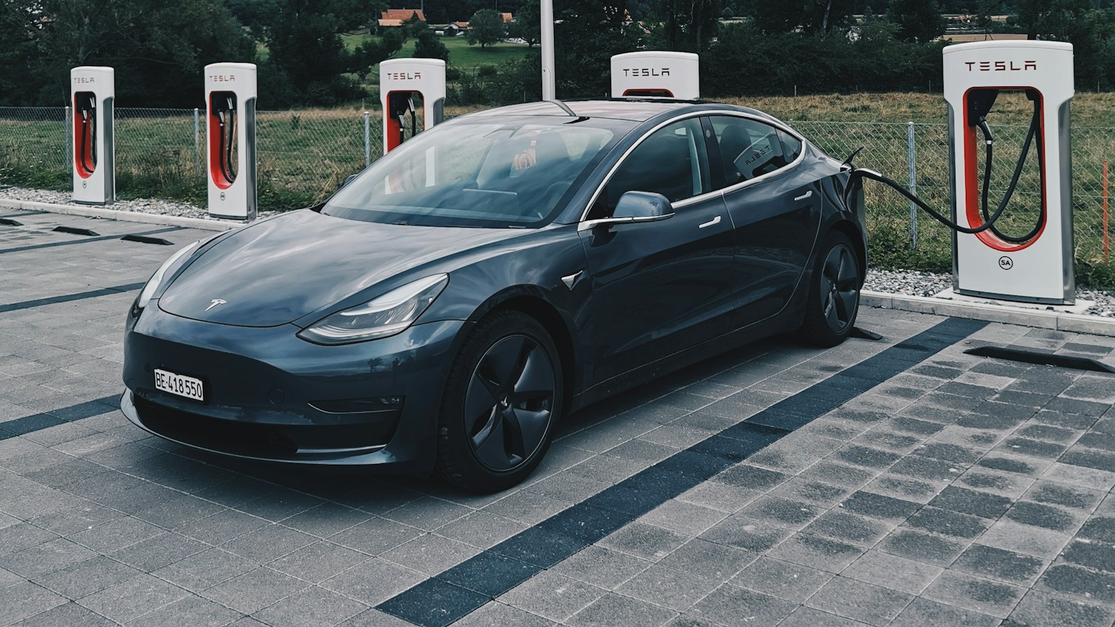 Tesla Model 3 charging at a Tesla Supercharger station