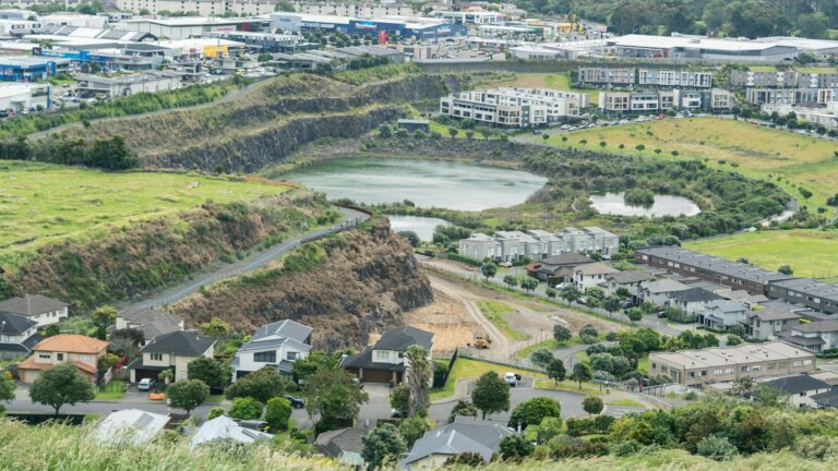 Aerial view of a New Zealand suburb with houses around a former quarry lake