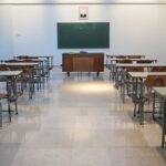 Empty school classroom with desks, chairs and a chalkboard in New Zealand