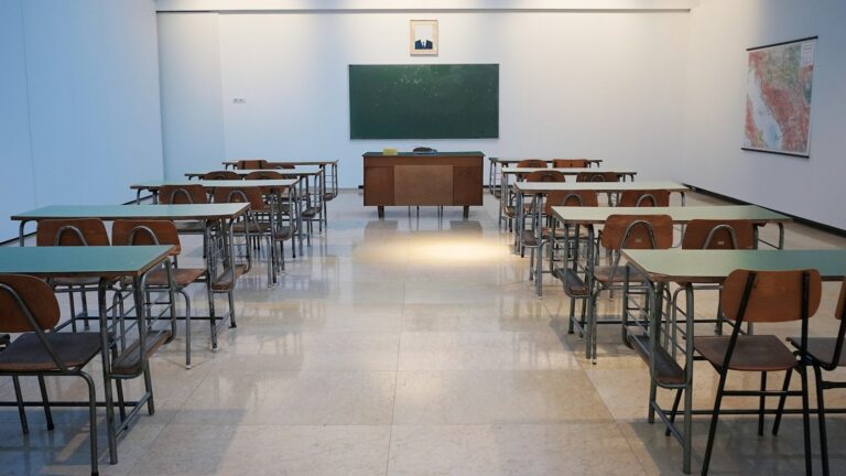 Empty school classroom with desks, chairs and a chalkboard in New Zealand