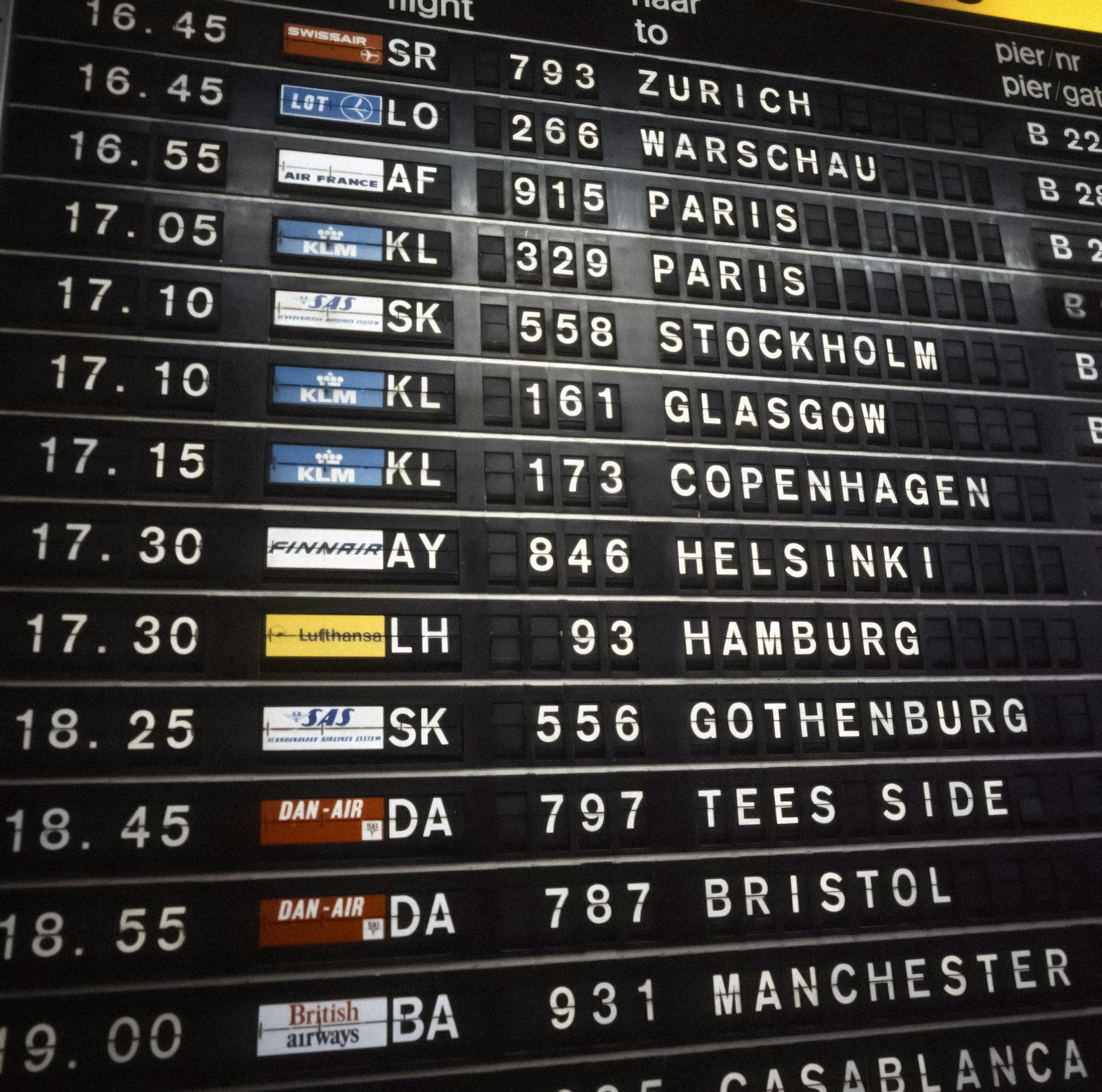 Airport departure board listing flight times and destinations